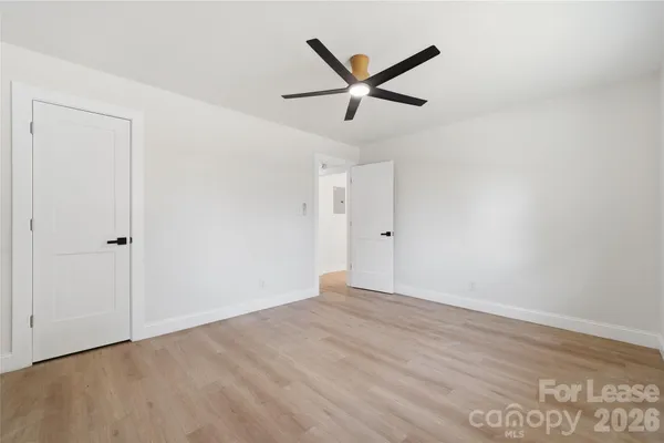 a view of a big room with wooden floor and closet area