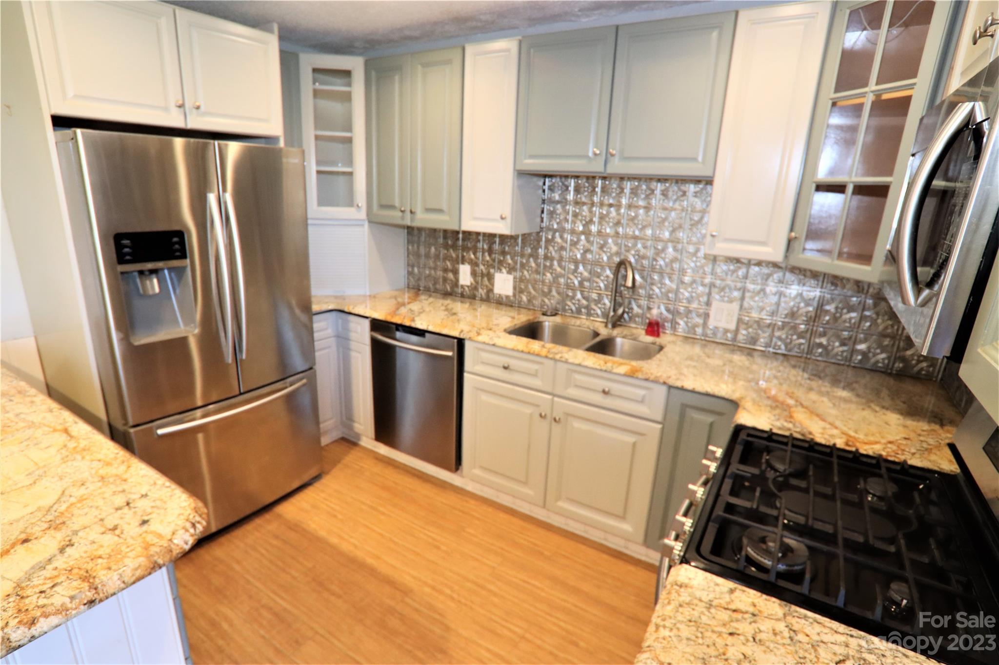 12725 Mooresville Road Mount Ulla, NC 28125 - Photo 12 of 23 a kitchen with stainless steel appliances a refrigerator sink and stove