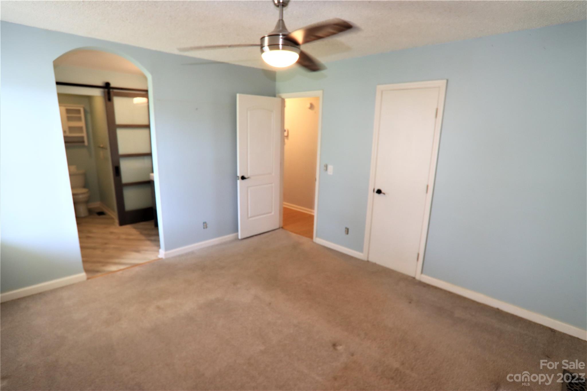 12725 Mooresville Road Mount Ulla, NC 28125 - Photo 15 of 23 an empty room with windows and fan