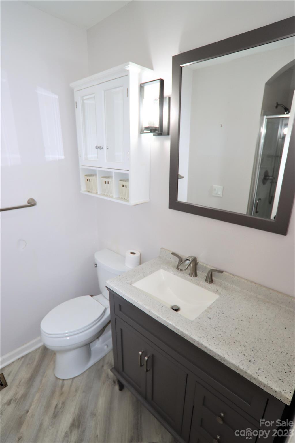 12725 Mooresville Road Mount Ulla, NC 28125 - Photo 19 of 23 a bathroom with a granite countertop toilet sink and mirror