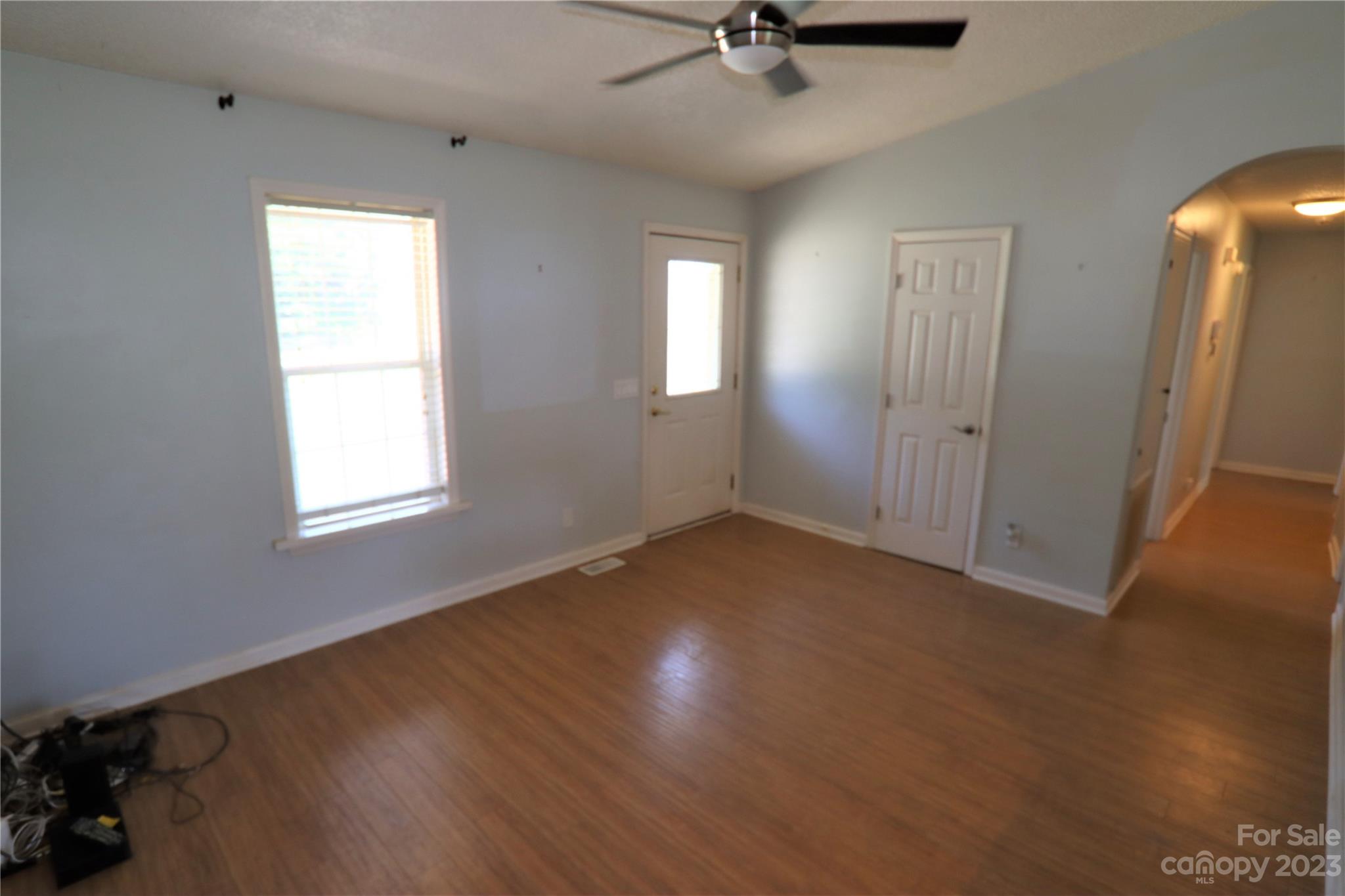 12725 Mooresville Road Mount Ulla, NC 28125 - Photo 2 of 23 a view of an empty room with a window and wooden floor
