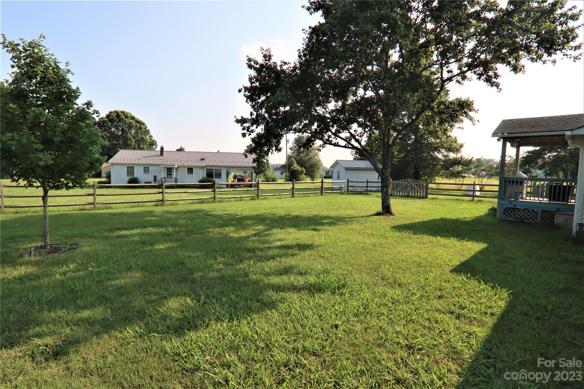 12725 Mooresville Road Mount Ulla, NC 28125 - Photo 22 of 23 a view of a big yard with a fountain and large trees