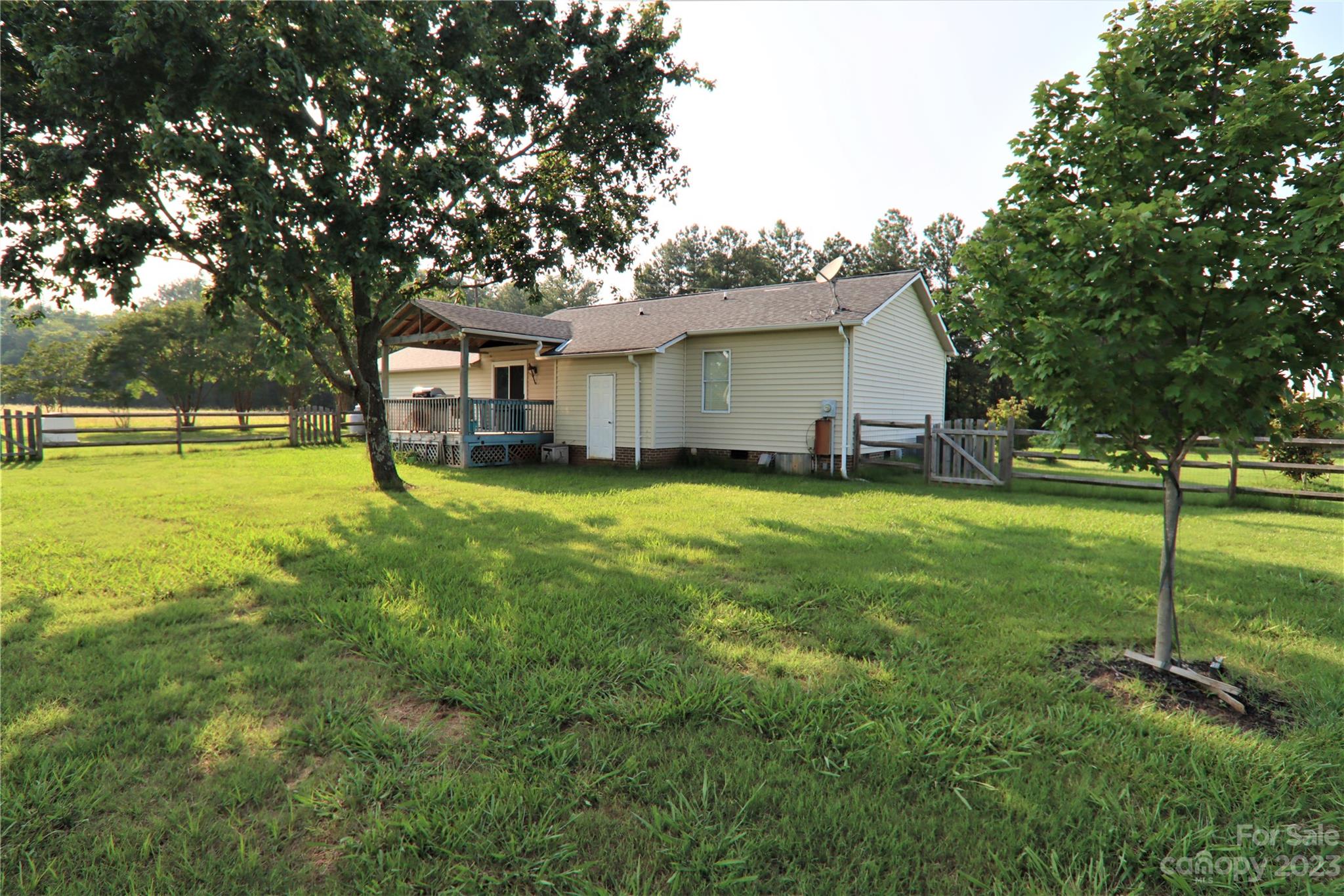 12725 Mooresville Road Mount Ulla, NC 28125 - Photo 23 of 23 a view of a house with a yard and tree s