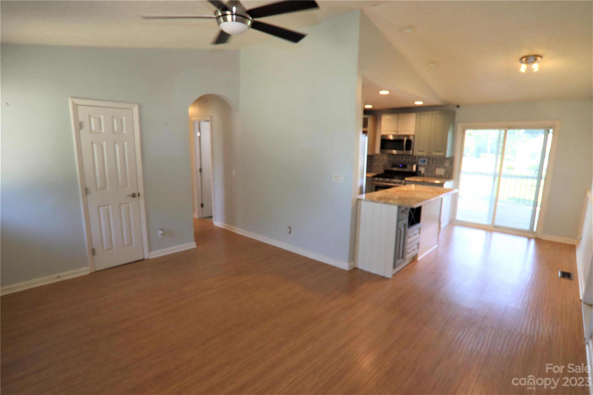 12725 Mooresville Road Mount Ulla, NC 28125 - Photo 3 of 23 a view of kitchen and empty room with wooden floor
