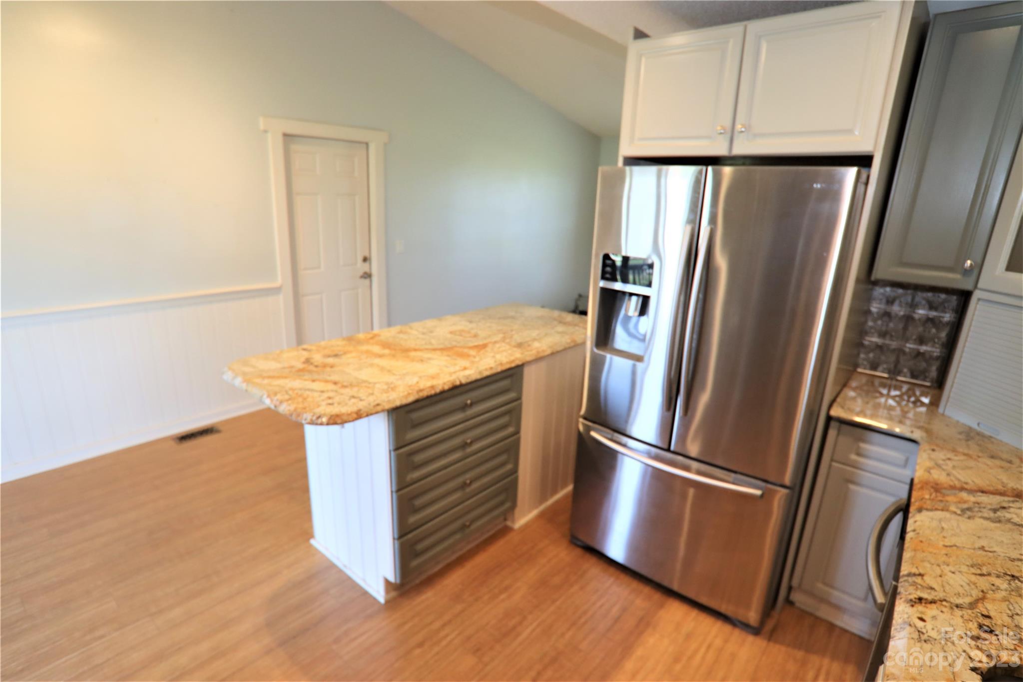 12725 Mooresville Road Mount Ulla, NC 28125 - Photo 5 of 23 a kitchen with stainless steel appliances a refrigerator and wooden floor