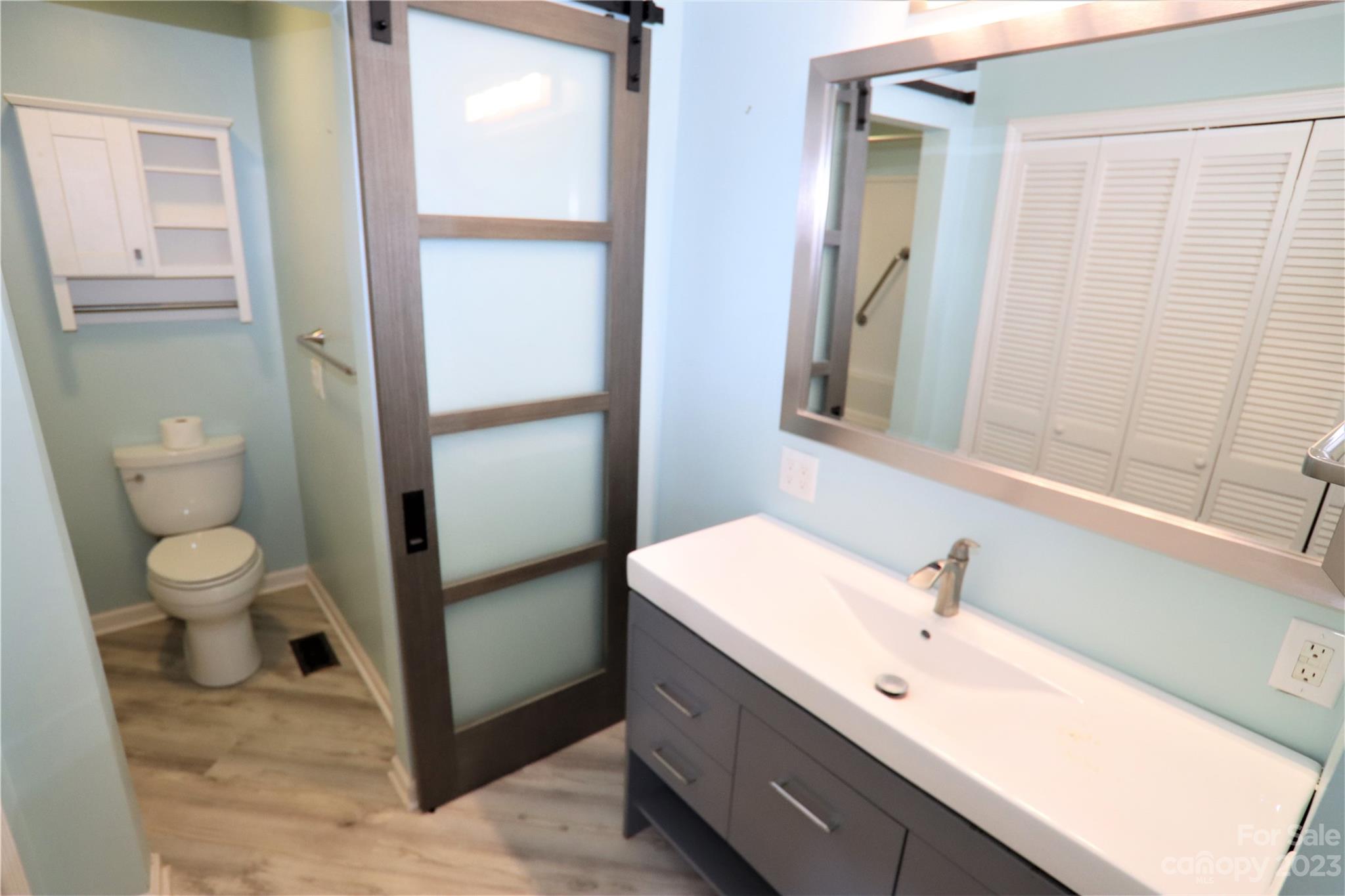12725 Mooresville Road Mount Ulla, NC 28125 - Photo 7 of 23 a bathroom with a double vanity sink toilet and shower