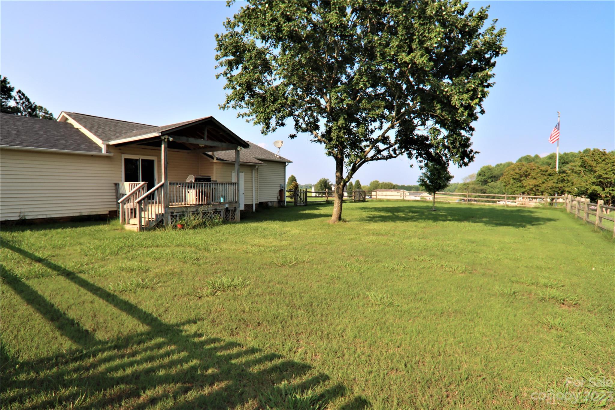 12725 Mooresville Road Mount Ulla, NC 28125 - Photo 8 of 23 a yellow house with trees in front of it