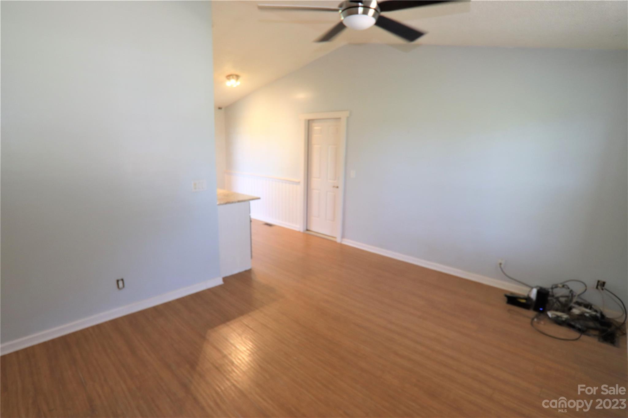 12725 Mooresville Road Mount Ulla, NC 28125 - Photo 10 of 23 a view of a room with wooden floor and white walls
