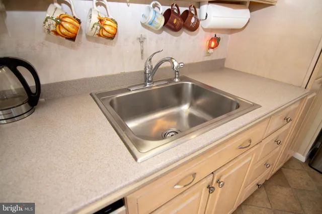 a view of a kitchen cabinets and a refrigerator