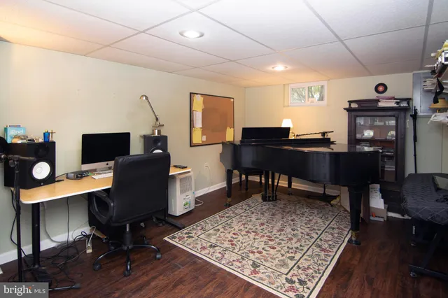 a view of workspace with wooden floor and windows
