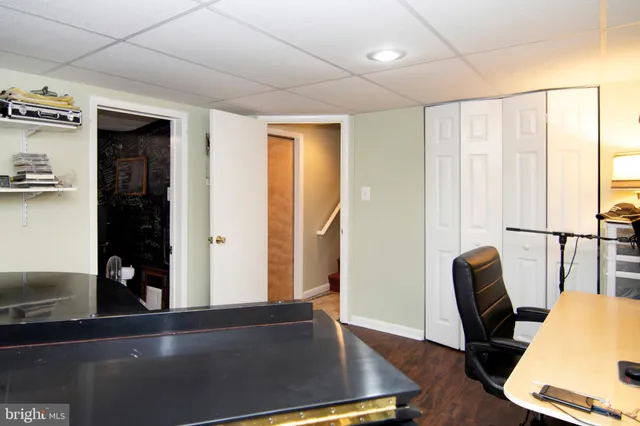 a view of a workspace with furniture and a window