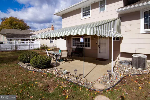 a view of a patio with table and chairs and potted plants