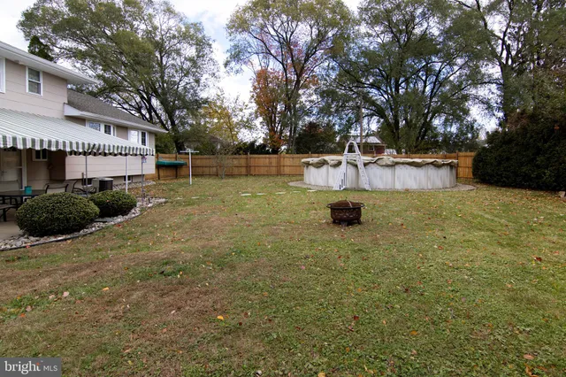 a swimming pool with outdoor seating and yard