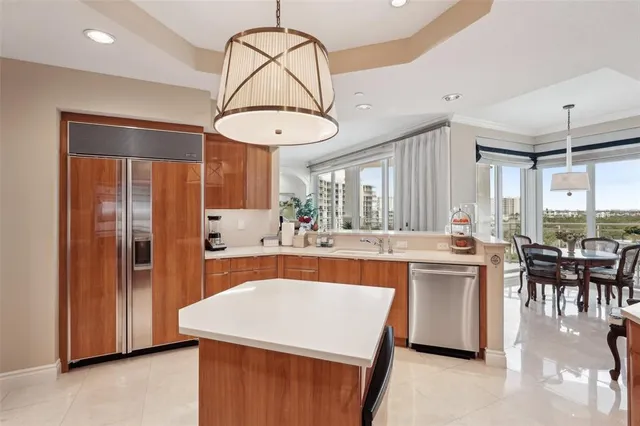 a large kitchen with kitchen island a table and chairs in it