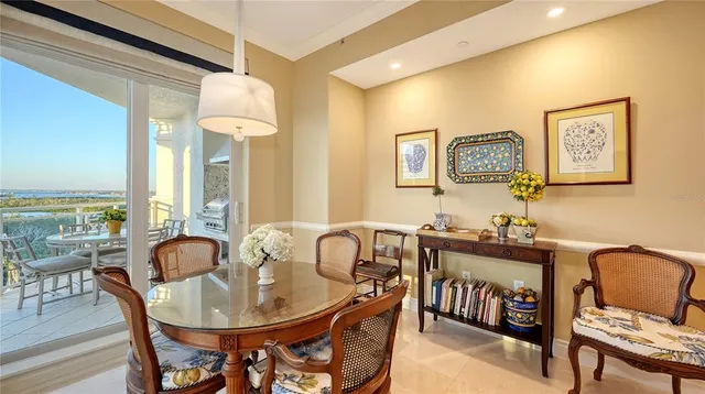 a view of a dining room with furniture and chandelier