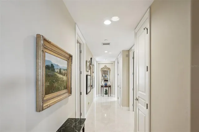 a view of a hallway with wooden floor and dining room