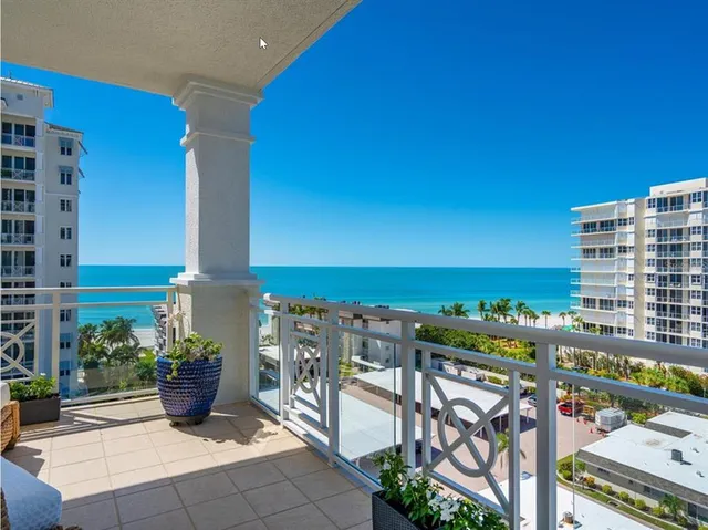 a view of a chairs and table in the back yard of a building