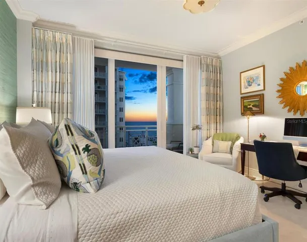 a living room with furniture two lamps and a large window