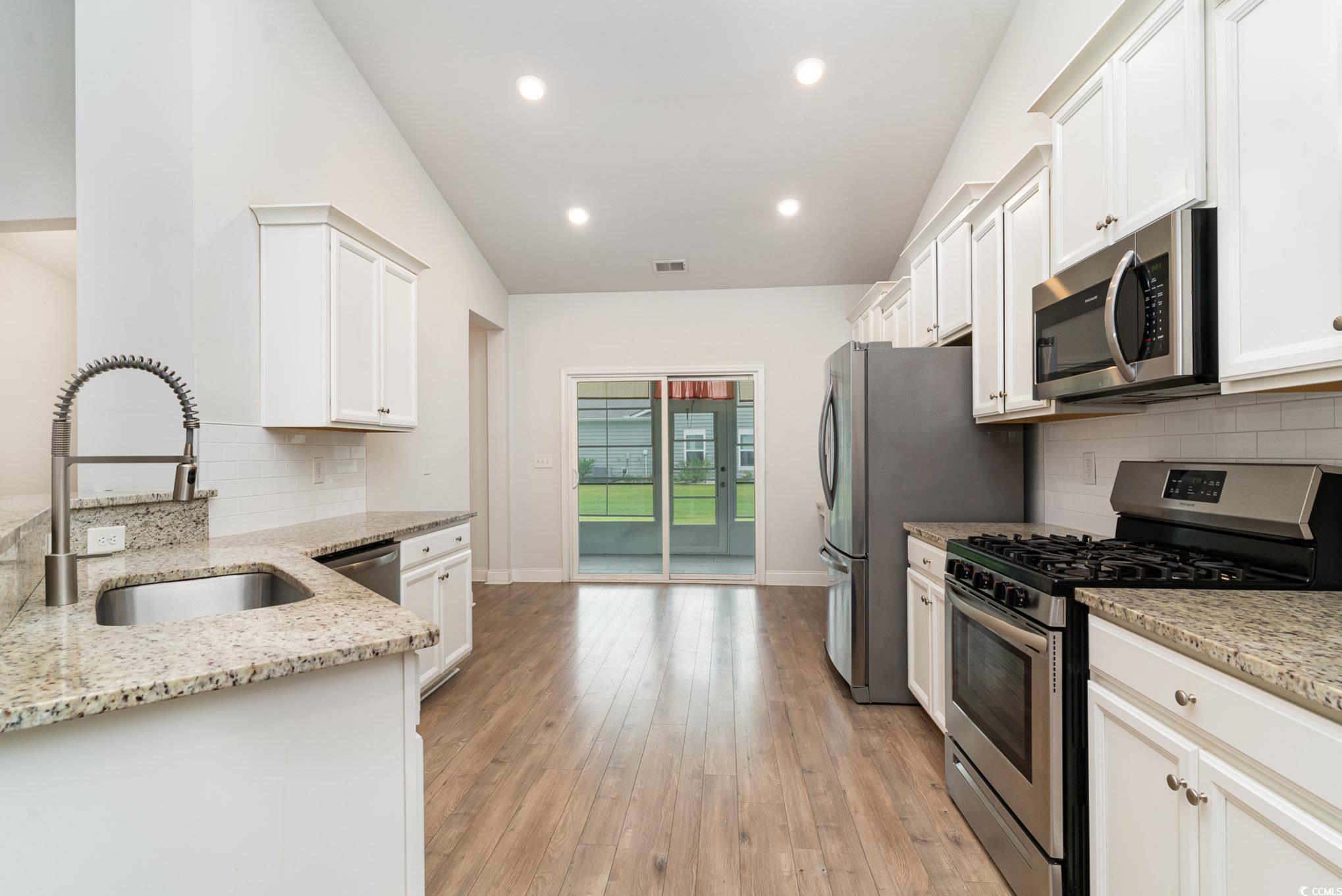 837 Brant Street Myrtle Beach, SC 29579 - Photo 8 of 40 Kitchen with stainless steel appliances, backsplas