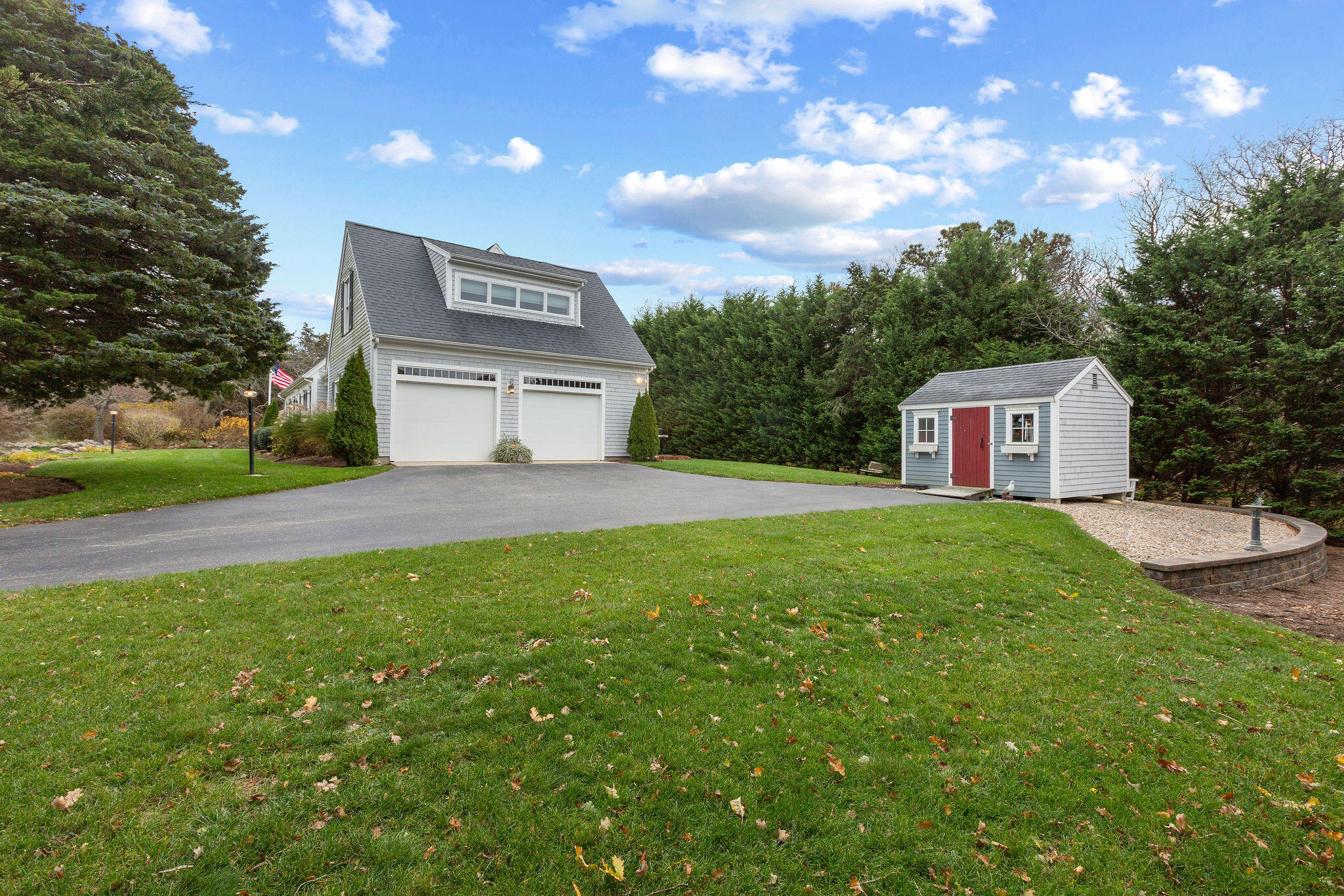 13 Hayfield Road East Dennis, MA 02641 - Photo 5 of 51 a view of a white house with a big yard and large trees
