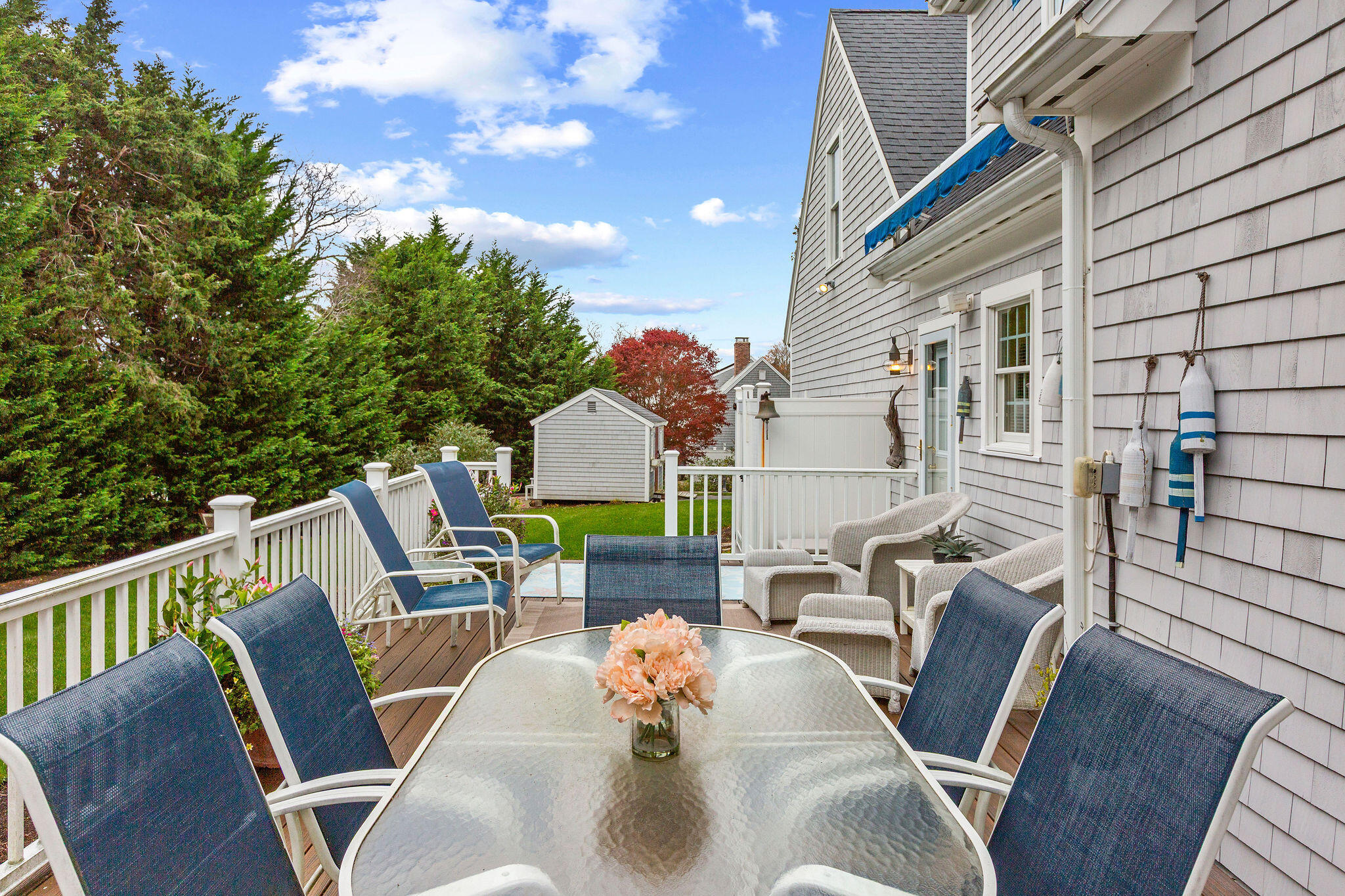 13 Hayfield Road East Dennis, MA 02641 - Photo 10 of 51 a view of a patio with couches chairs under an umbrella with wooden floor