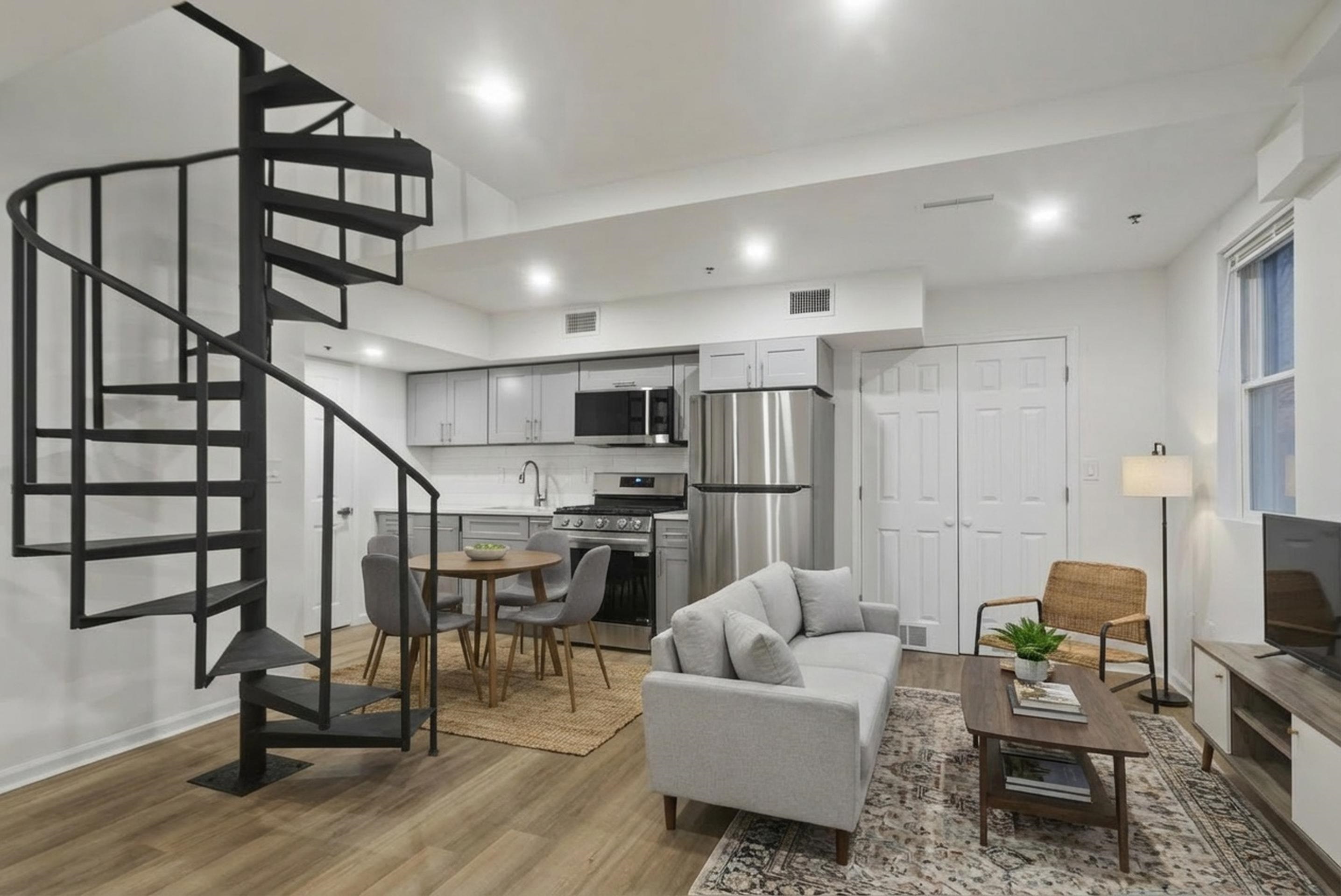 419 5th Street, Unit A Hoboken, NJ 07030 - Photo 1 of 16 a living room with lots of furniture and a flat screen tv