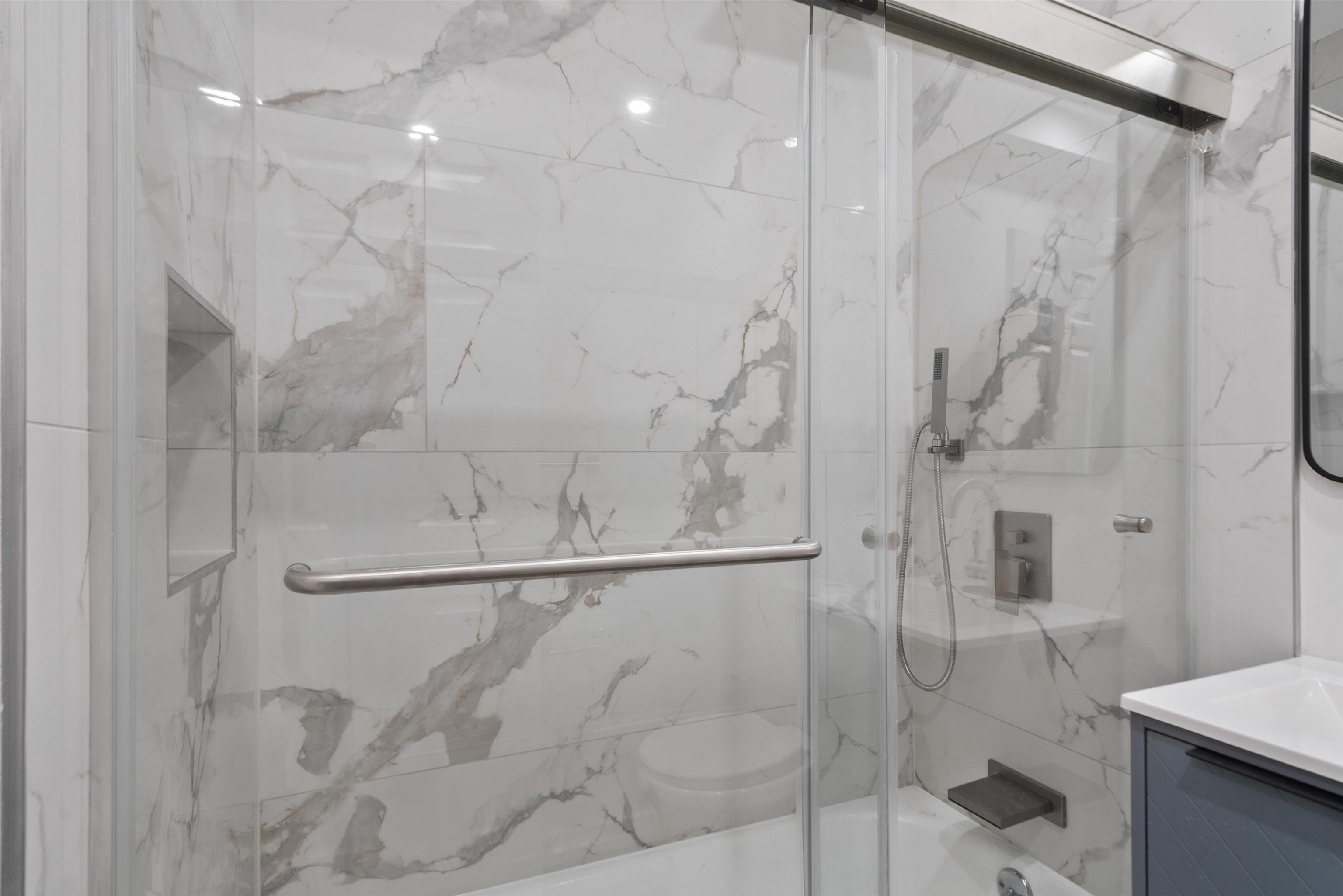 419 5th Street, Unit A Hoboken, NJ 07030 - Photo 12 of 16 a bathroom with a shower and a mirror