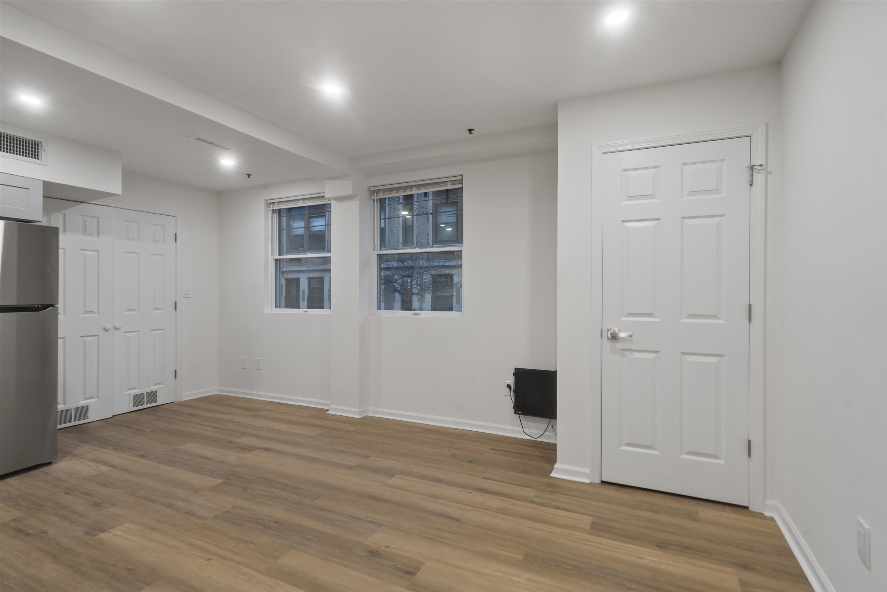 419 5th Street, Unit A Hoboken, NJ 07030 - Photo 3 of 16 a view of empty room with wooden floor and cabinet