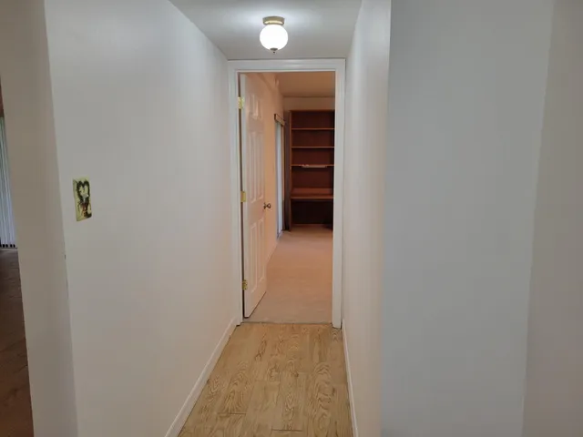 an empty room with closet and windows