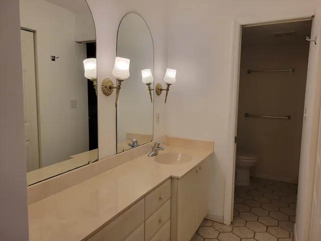 a bathroom with a glass shower door