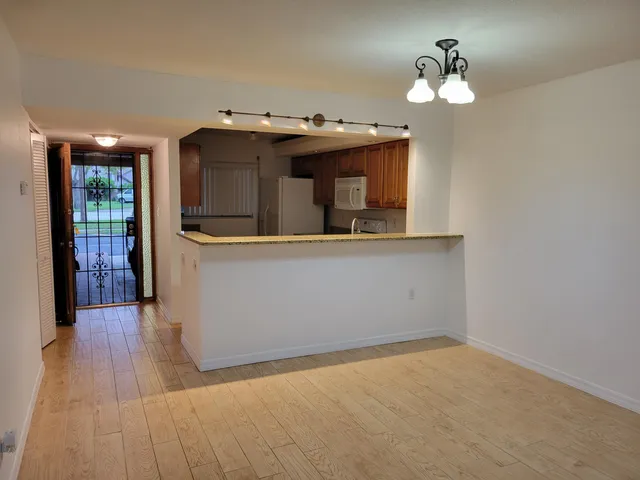a view of a room with wooden floor and chandelier