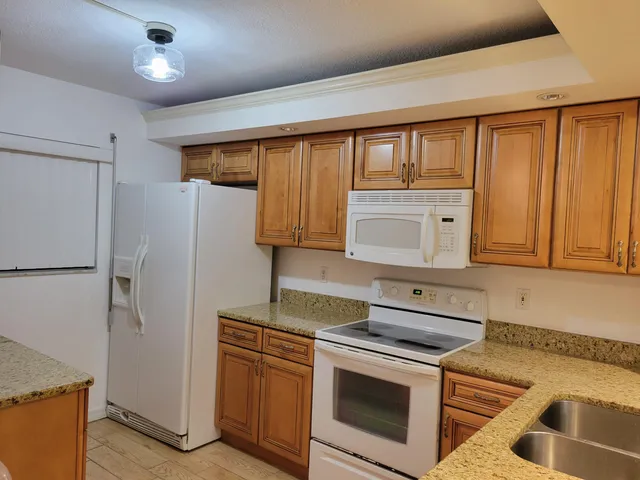 a kitchen with a refrigerator and a sink