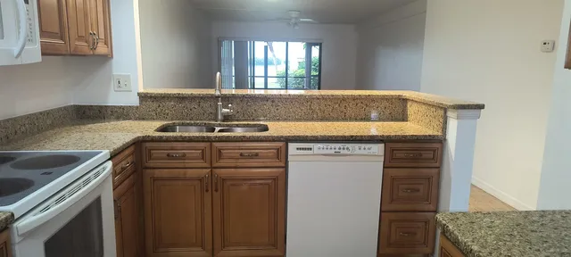 a view of a kitchen with sink and dishwasher