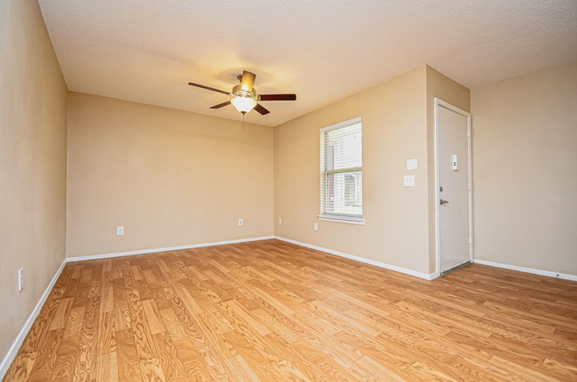 427 Martin Street Chandler, TX 75758 - Photo 5 of 11 a view of an empty room with window and wooden floor