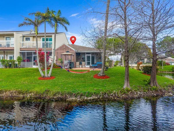a car parked in front of a white house