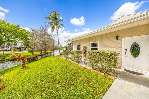 a dining room with furniture a chandelier and wooden floor