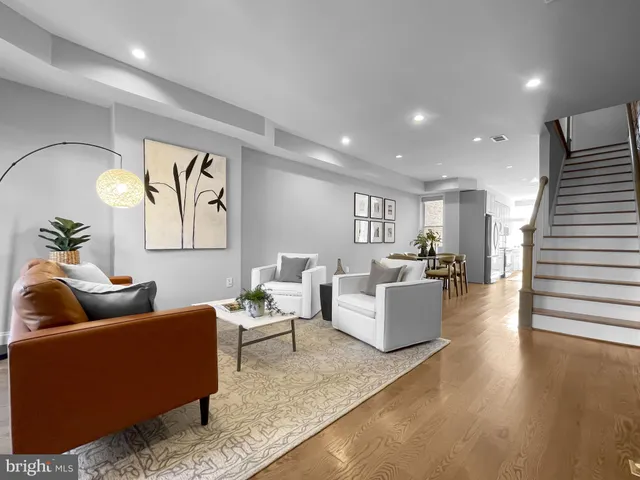 a living room with furniture and wooden floor