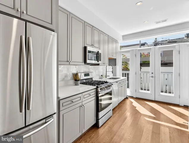 a kitchen with stainless steel appliances a refrigerator stove and sink