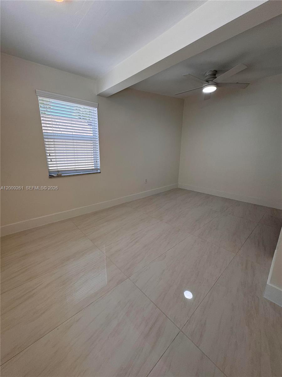606 Southwest 58th Court, Unit 1 Miami, FL 33144 - Photo 4 of 7 a view of an empty room with a window
