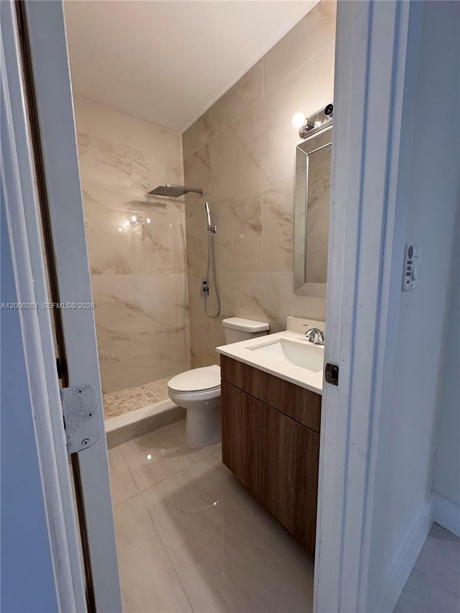 606 Southwest 58th Court, Unit 1 Miami, FL 33144 - Photo 6 of 7 a bathroom with a sink a toilet and shower