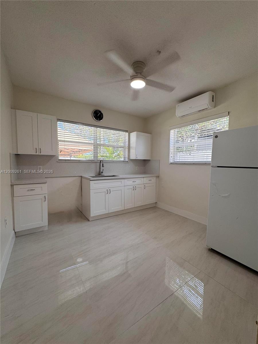 606 Southwest 58th Court, Unit 1 Miami, FL 33144 - Photo 7 of 7 a large kitchen with a cabinets stainless steel appliances and a window