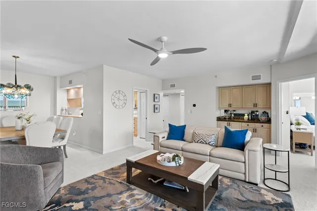 a living room with furniture and view of kitchen
