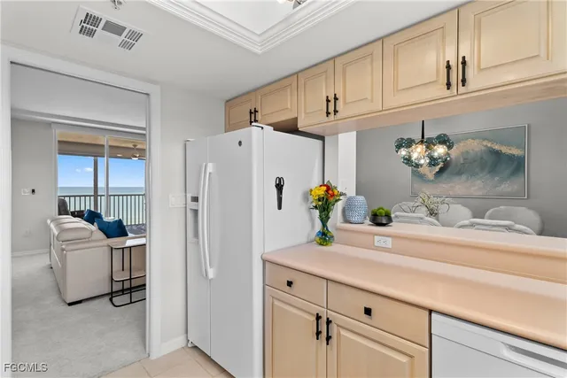 a kitchen with stainless steel appliances a white refrigerator a microwave and cabinets