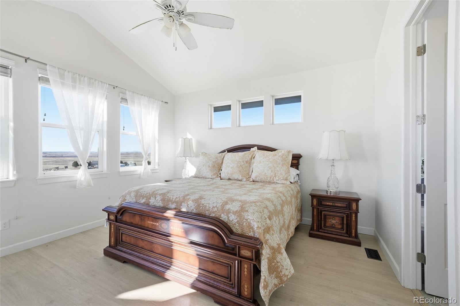 7600 Patrick Trail Elizabeth, CO 80107 - Photo 35 of 50 a bedroom with a bed and a chandelier