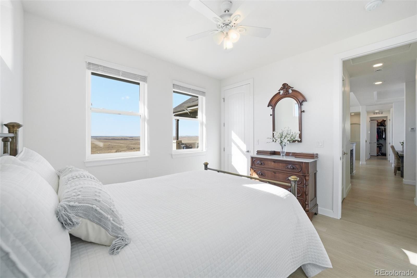 7600 Patrick Trail Elizabeth, CO 80107 - Photo 40 of 50 a bedroom with a bed and a chandelier