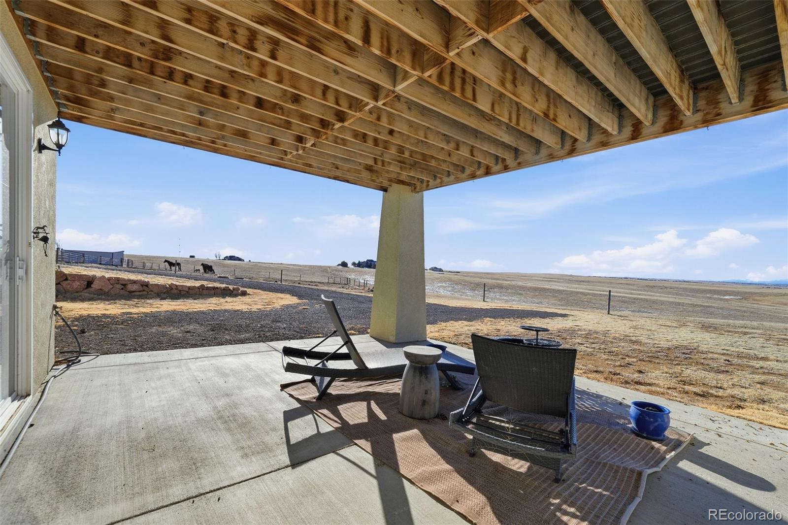 7600 Patrick Trail Elizabeth, CO 80107 - Photo 45 of 50 a view of a terrace with lawn chairs and ocean view