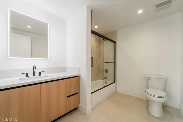 a bathroom with a toilet sink and shower