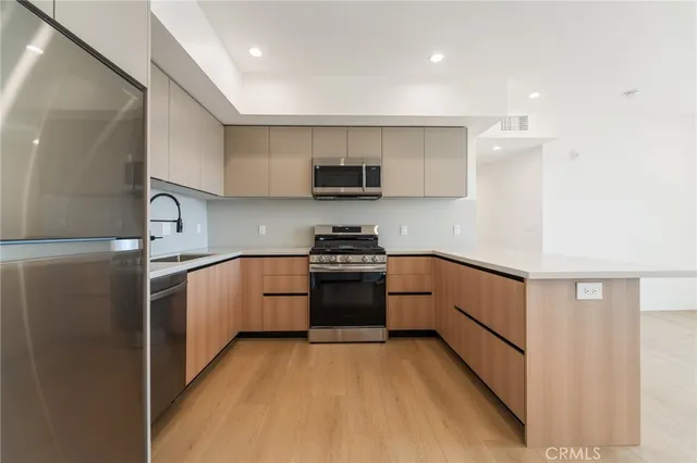 a kitchen with a sink and a stove top oven