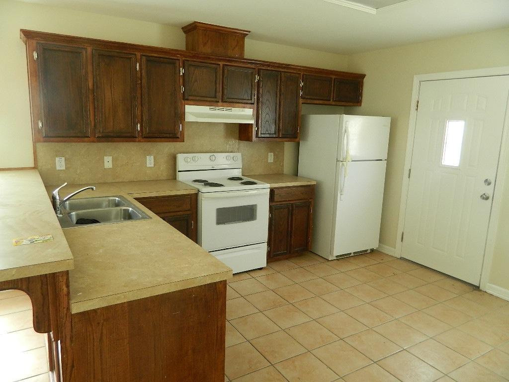 1100 East Santa Rosa Avenue Edcouch, TX 78538 - Photo 6 of 6 a kitchen with a sink a stove and refrigerator