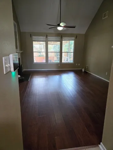wooden floor in an empty room with a window